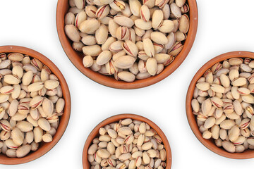 Top view of pistachios filled in four clay bowls on a white surface. Food photography of pistachios with top view. Pistachios in a clay bowl for facebook post.