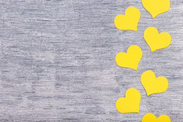 yellow hearts on grey background, flat lay, trendy colors 2021