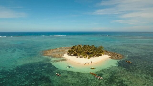 aerial footage tropical island with beach and palm trees lagoon with turquoise water Sea tropical landscape Guyam island, Philippines, Siargao. Travel concept Aerial video