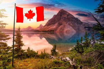 Canadian National Flag. Beautiful Nature landscape view of Bow Lake in Banff National Park, Alberta, Canada. Dramatic Colorful Stormy Sky. Scenic Background