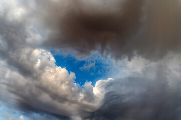 Naklejka na ściany i meble Dramatic panoramic skyscape with the dark stormy clouds