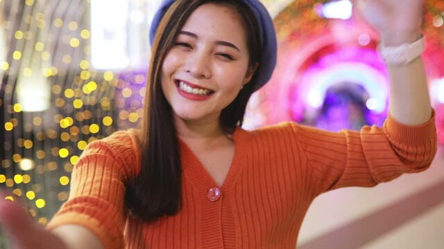 Happy young asian woman taking a selfie photo near christmas tree at home celebrating New Year. Female teen happy smiling celebrate xmas winter holidays .Blogger asian girl live social media.