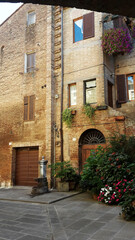 Fototapeta na wymiar Old stone house in an italian courtyard