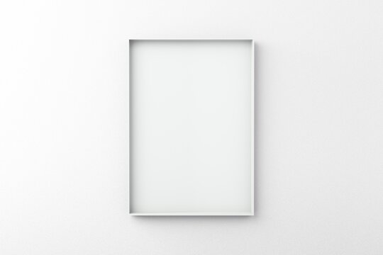 Thin metal empty frame on white wall for mockup