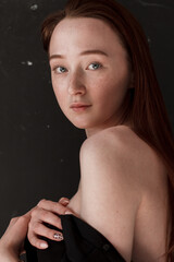 portrait of a young redhead young woman with freckles