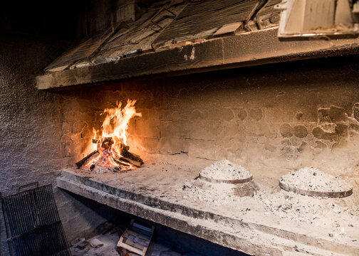 An old traditional stone hearth with a fire on Mljet Island in Croatia