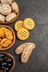 top view delicious sweet cakes with cookies and olives on a dark background pie cake sweet