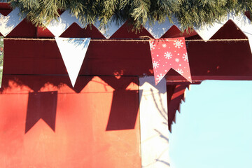 Festive New Year's flags on the wall of the house, the shadow of the flag. Winter day. Close-up
