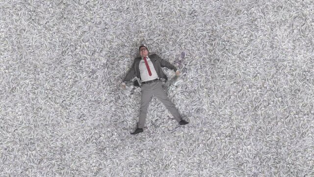 happy man business man portrays snow angel in banknotes