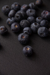 dark blue blueberries on a dark background