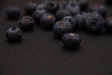 dark blue blueberries on a dark background