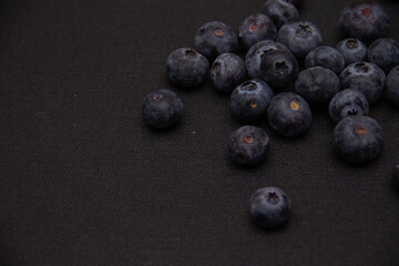 dark blue blueberries on a dark background