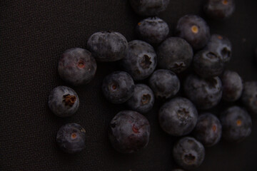 dark blue blueberries on a dark background