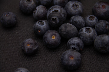 dark blue blueberries on a dark background