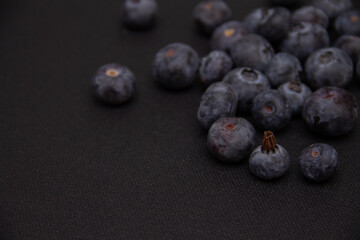 dark blue blueberries on a dark background