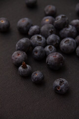 dark blue blueberries on a dark background