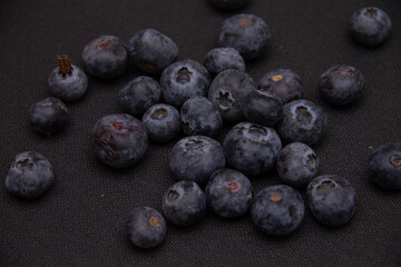 dark blue blueberries on a dark background