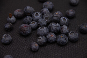 dark blue blueberries on a dark background