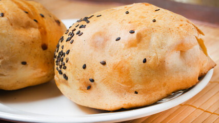 Uzbek tandoor samsa with meat and sesame seeds