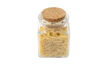 In Greece called kritharaki. In Italy called Orzo. Rice shaped pasta in a glass jar isolated on white background. Type of pasta. Food ingredient.