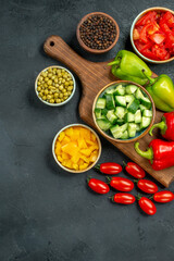 top view of plate stand with vegetables over and near to it on dark greyish background