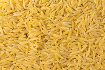 In Greece called kritharaki. In Italy called Orzo. Rice shaped pasta background. Type of pasta....