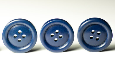 Group of blue round plastic buttons isolated on white background. Close up. Macro.