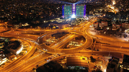 Fototapeta na wymiar Aerial drone slow shutter night photo of illuminated urban elevated toll ring road junction and interchange overpass passing through Kifisias Avenue, Attica, Greece