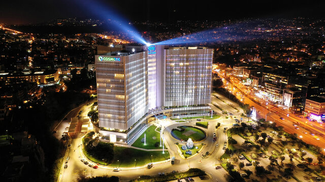 Aerial drone night shot of public Hellenic Telecommunication headquarters known as OTE and COSMOTE illuminated for Christmas holidays, &Alpha;thens, Attica, Greece