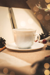 Cozy vertical composition with a cup of hot drink, evening dinner, bokeh and warm shades