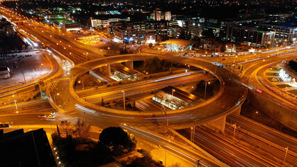Aerial drone slow shutter night slow shutter shot of multilevel junction ring road passing through city centre 