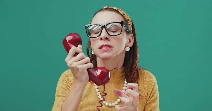 Funny angry woman speaking on a telephone.