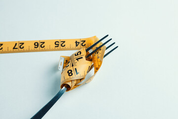 Dieting concept with fork and meter