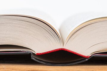 Macro of open book on wooden table