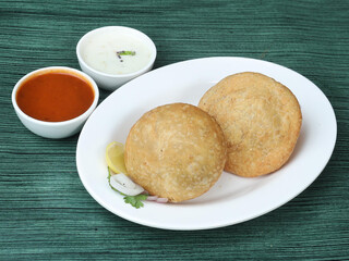 Kachori a famous midday snack in india, served over a rustic wooden background, selective focus