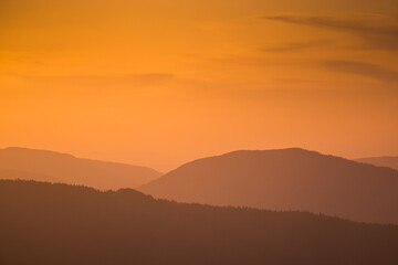 The sunset in the mountains in warm colors.