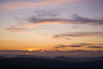 The sunset in the mountains in warm colors.