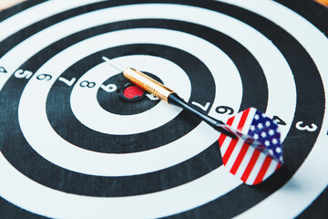 dart arrow hitting in the target center of dartboard.