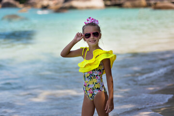 Child having fun at the beach, Cute girl playful in the sunny day, tropical beach.