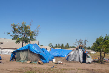 Refugee camp made of tents, people living in very poor conditions, lack of clean water, access to...