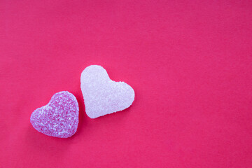  Heart shaped gummy candy on bright pink background, free space for text