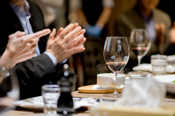 Wine glass on the dinner table at a company party