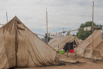 Refugee camp made of tents, people living in very poor conditions, lack of clean water, access to...