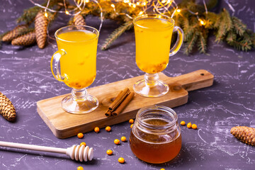 hot and healthy tea with sea buckthorn, honey and cinnamon. selective focus