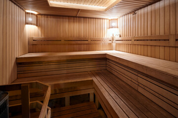 Russian sauna clean wooden bathhouse with stove and wooden lanterns hygrometer and thermometer. Bath and sauna are good means of preventing disorders of cardiovascular and respiratory systems.