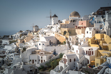 Fototapeta na wymiar Greece Traveling. View of Greek Traditional Colorful Houses and Windmills of Oia or Ia at Santorini Island in Greece