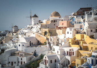 Greece Traveling. View of Greek Traditional Colorful Houses and Windmills of Oia or Ia at Santorini...