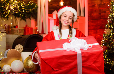 Rewarding concept. Child having fun christmas eve. Happiness and joy. Girl Santa claus costume...