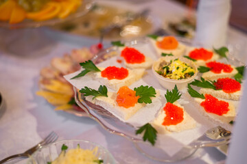 sandwiches with red caviar on the festive table