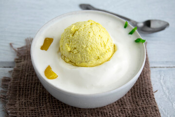  Ice cream in the form of fried eggs. Creative dessert in a white cup. Creative food for the holiday and good mood..